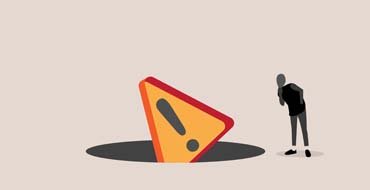 危険な落とし穴をのぞき込む人のイラスト